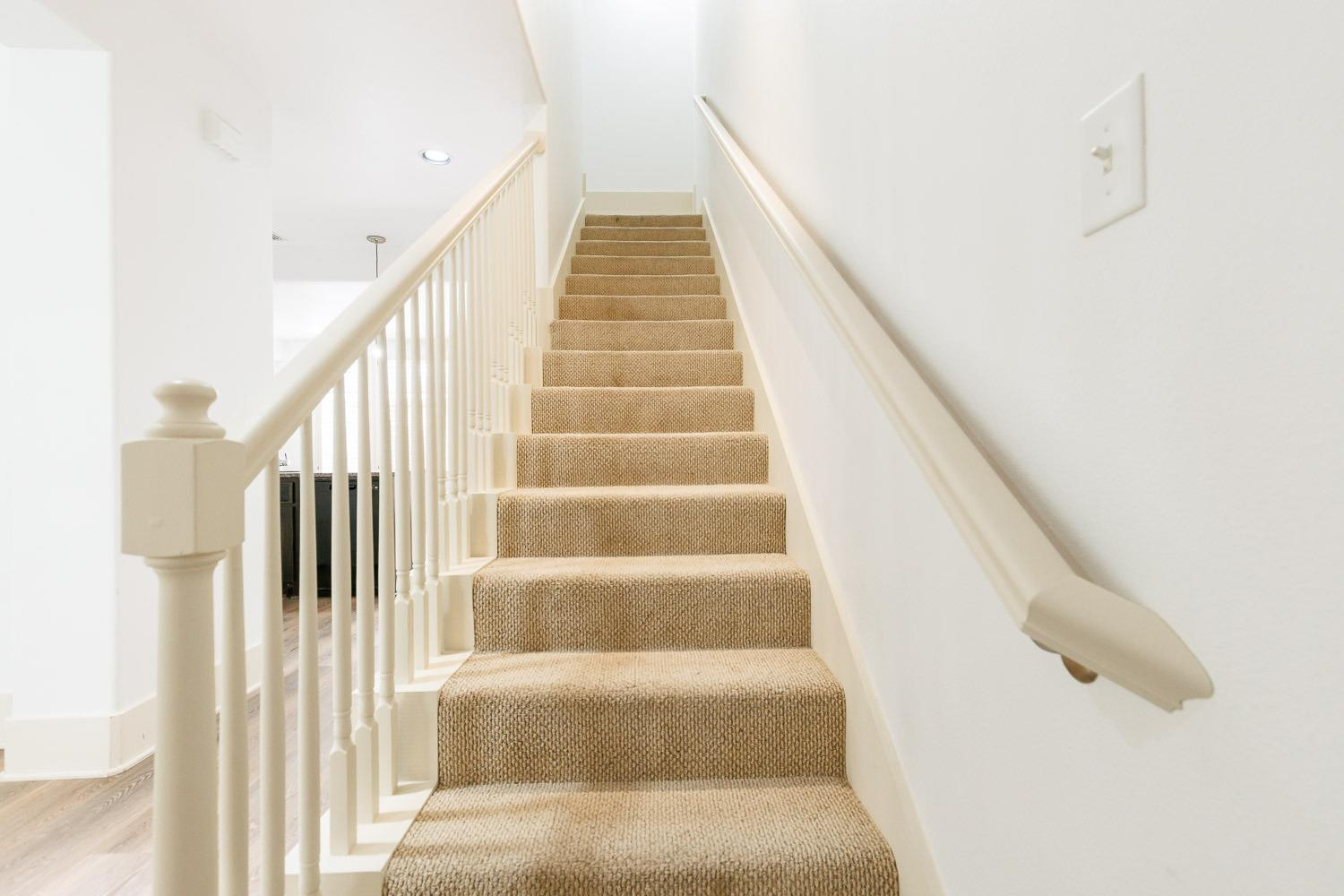 4612 121st Street Lubbock, TX 79424 - Photo 13 of 26 a view of staircase with lots of frames on wall