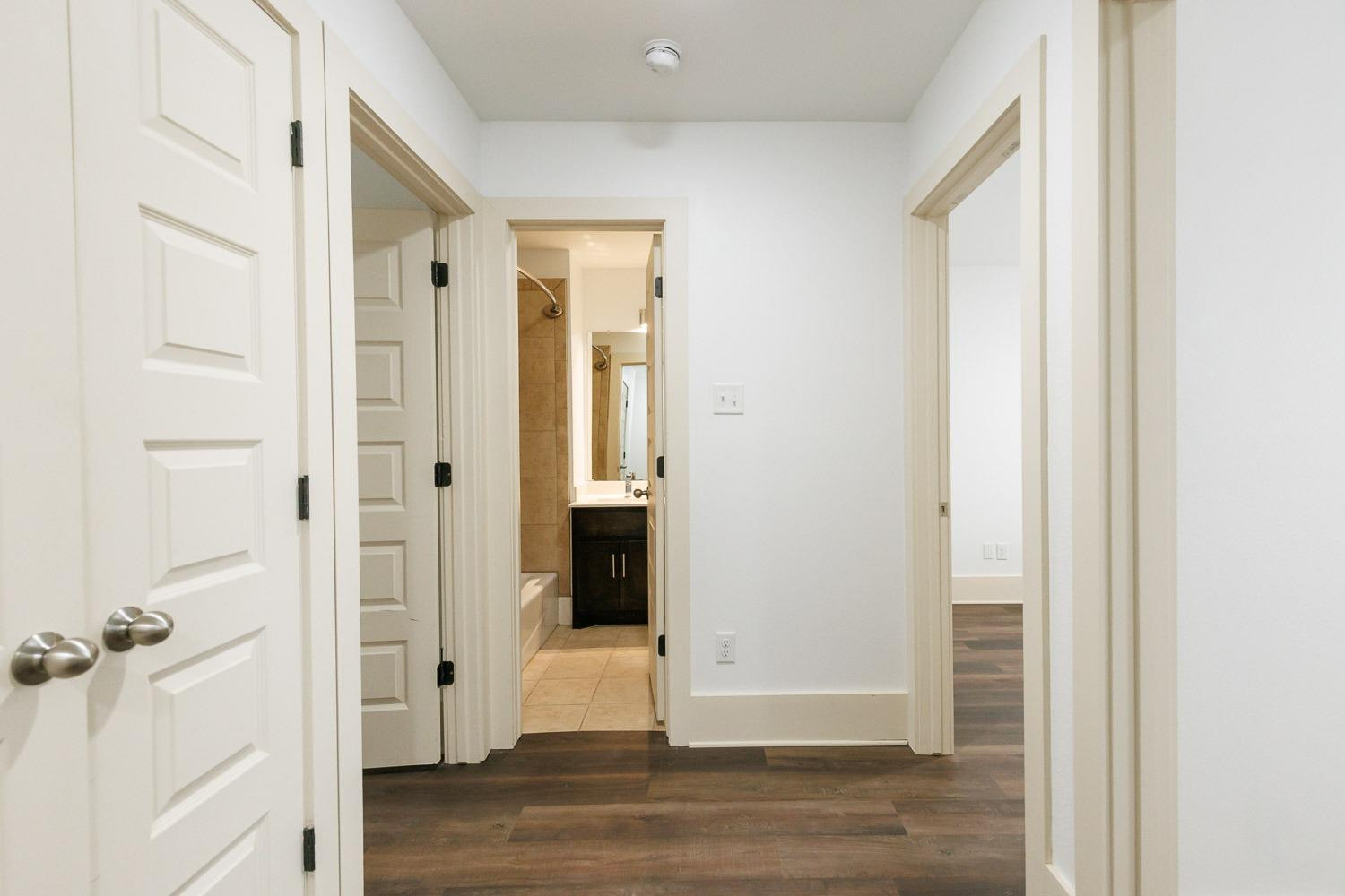 4612 121st Street Lubbock, TX 79424 - Photo 14 of 26 a view of a hallway with wooden floor and closet