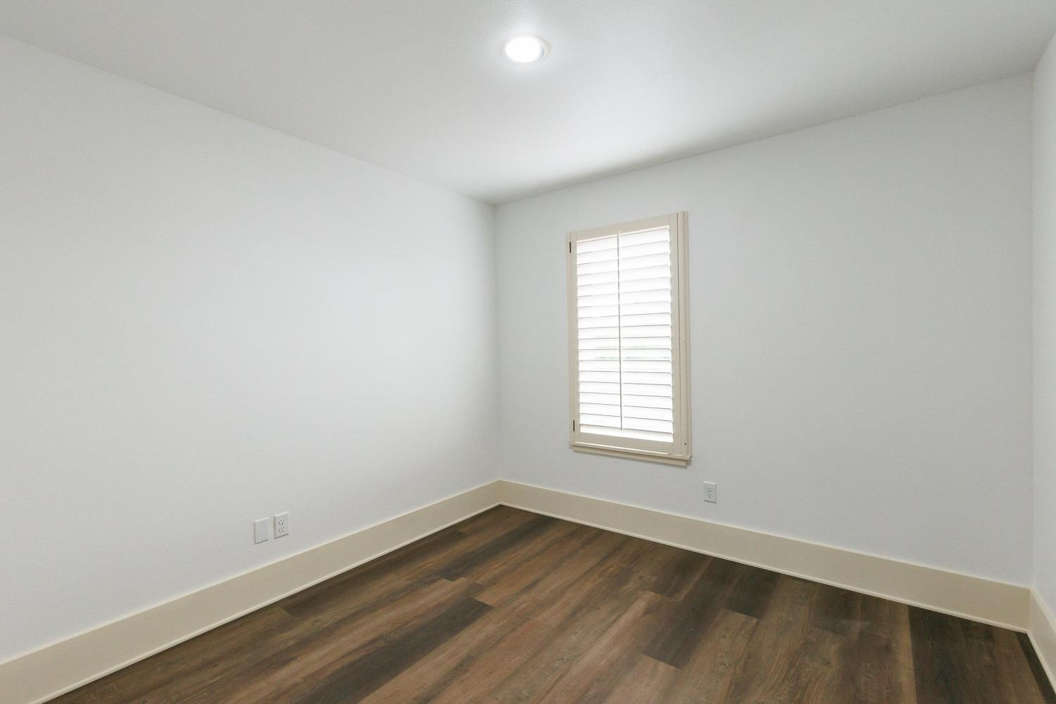 4612 121st Street Lubbock, TX 79424 - Photo 17 of 26 an empty room with wooden floor and window