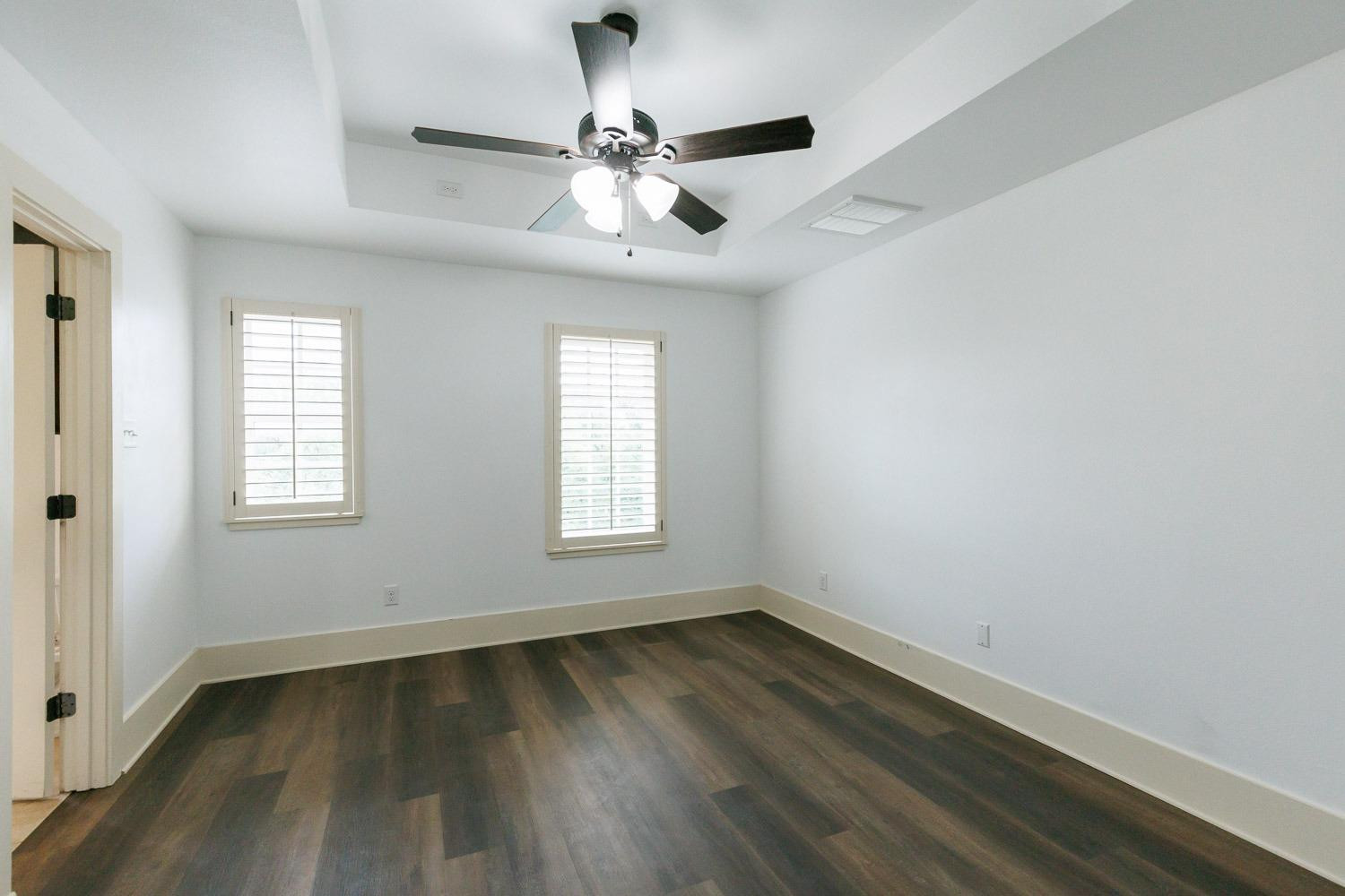 4612 121st Street Lubbock, TX 79424 - Photo 19 of 26 an empty room with wooden floor fan and windows