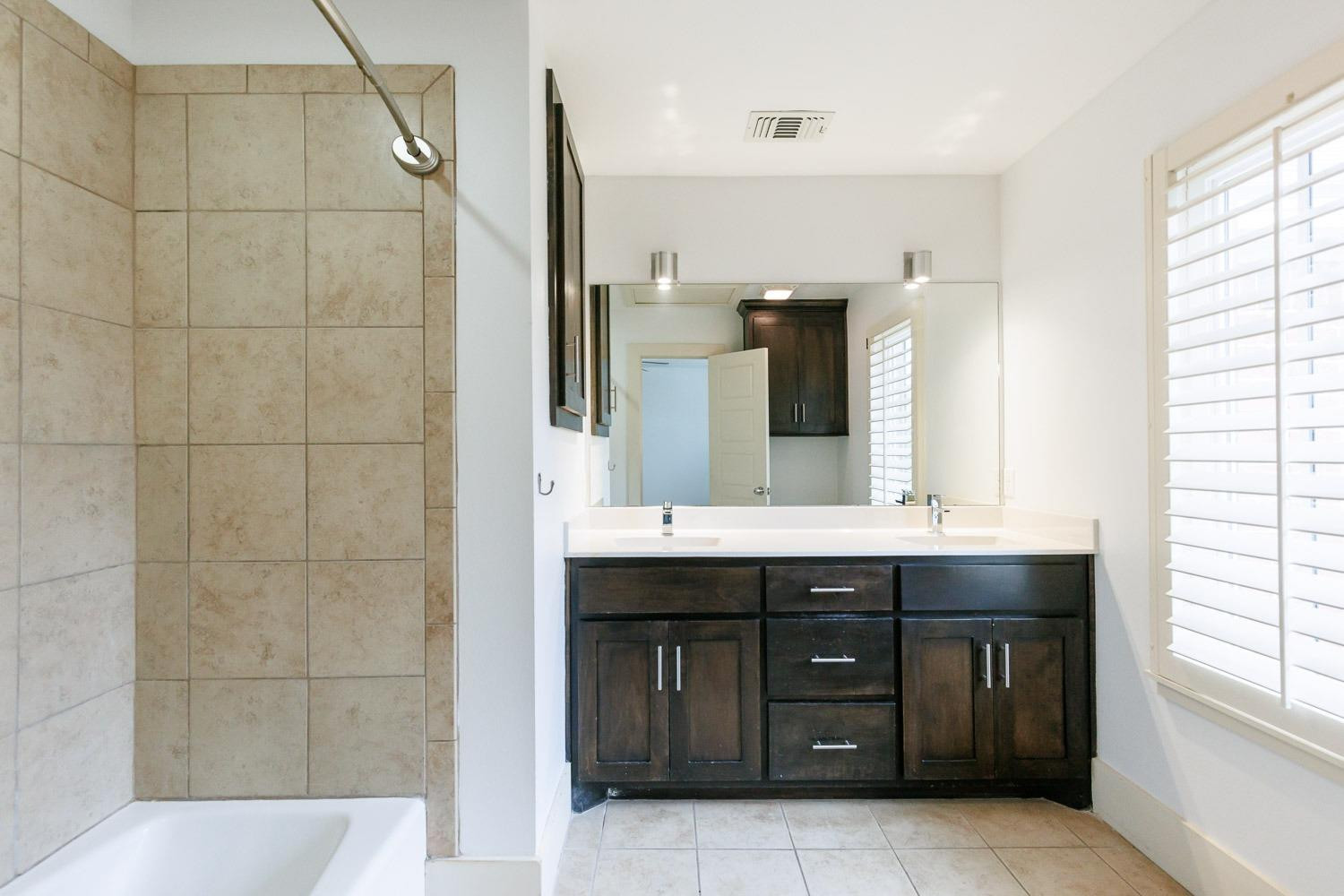 4612 121st Street Lubbock, TX 79424 - Photo 20 of 26 a bathroom with a double vanity sink mirror and double