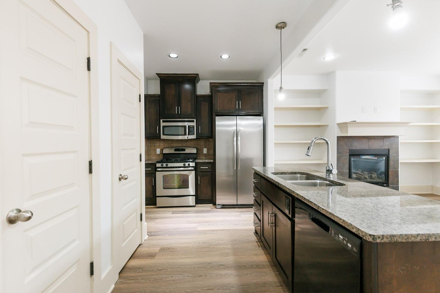 4612 121st Street Lubbock, TX 79424 - Photo 5 of 26 a kitchen with granite countertop kitchen island stainless steel appliances a refrigerator stove and oven