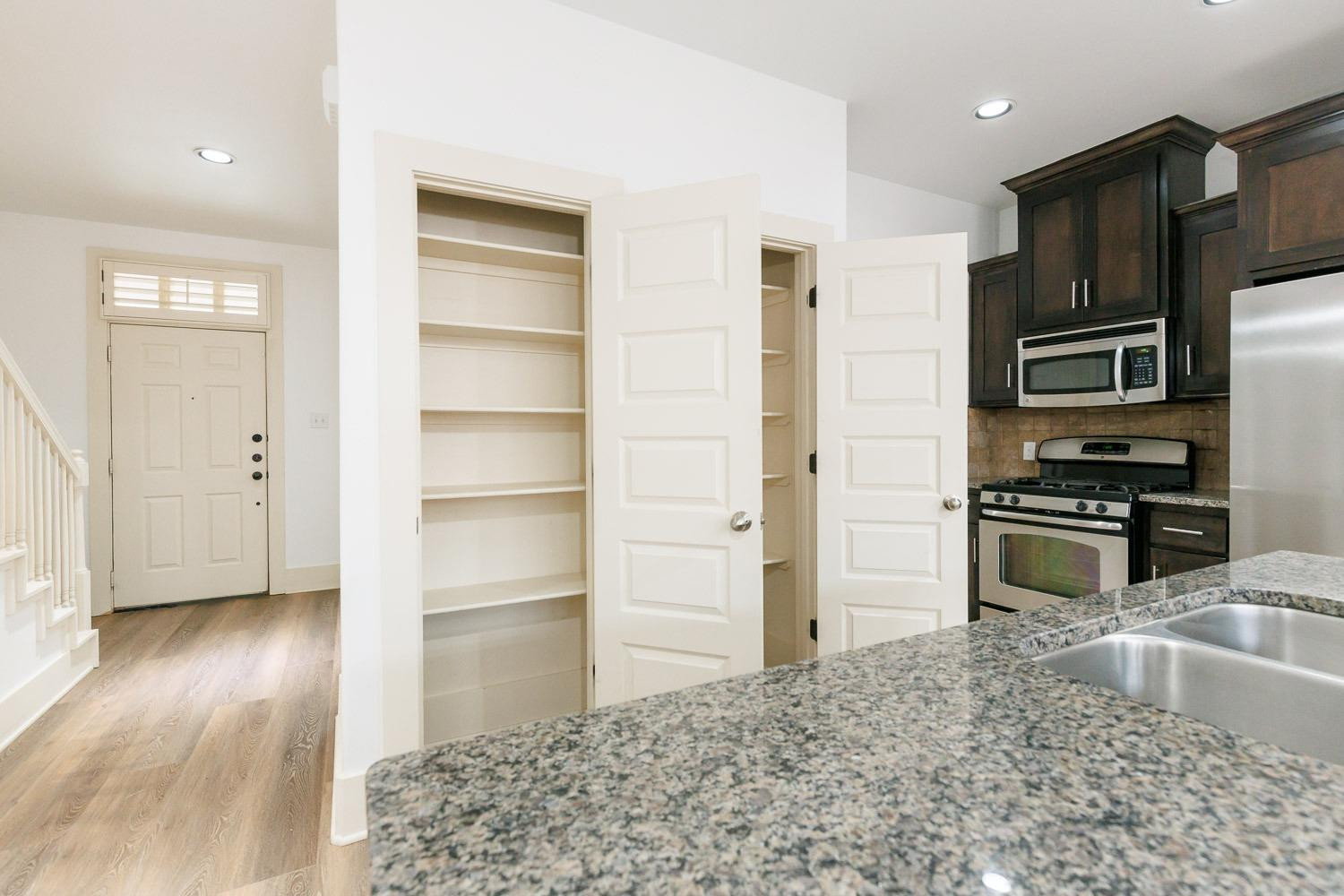 4612 121st Street Lubbock, TX 79424 - Photo 6 of 26 a kitchen with granite countertop a refrigerator and a sink