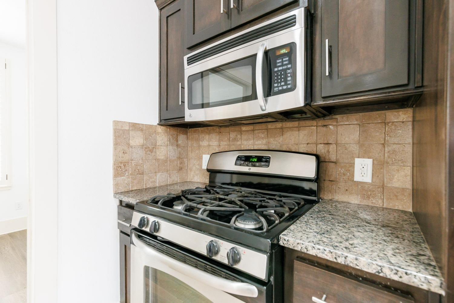 4612 121st Street Lubbock, TX 79424 - Photo 7 of 26 a stove top oven sitting inside of a kitchen