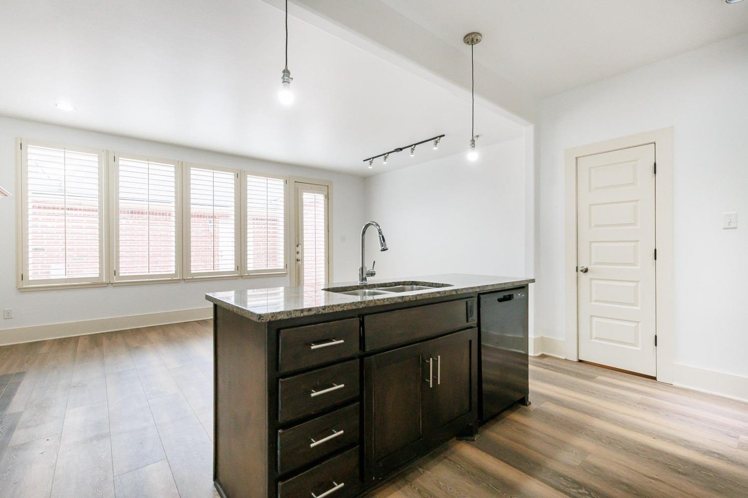 4612 121st Street Lubbock, TX 79424 - Photo 8 of 26 a kitchen with a sink and wooden floor