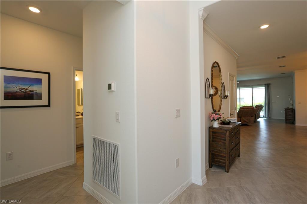 2155 Hamlin Street Naples, FL 34120 - Photo 29 of 50 Hallway with ornamental molding and light tile patterned floors