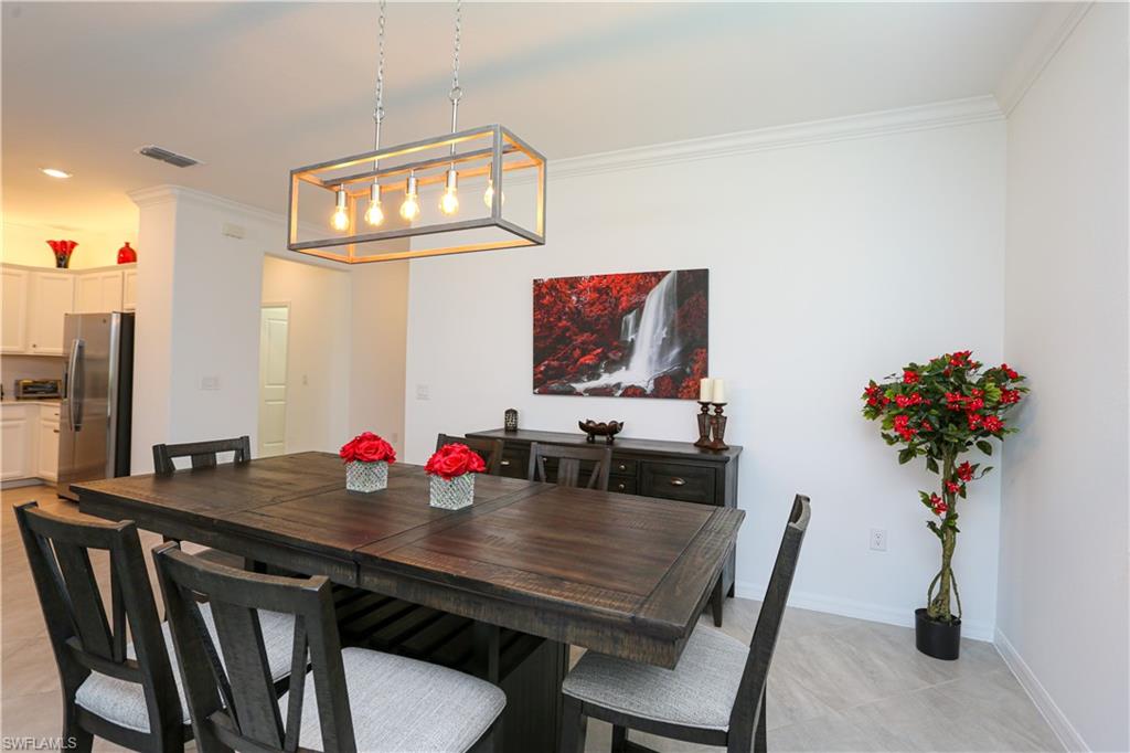 2155 Hamlin Street Naples, FL 34120 - Photo 42 of 50 Tiled dining room featuring ornamental molding