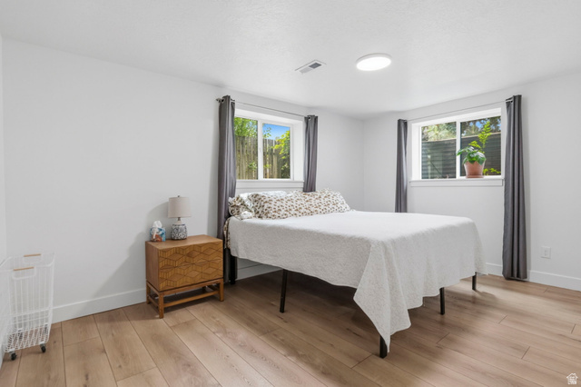 4150 Dover Lane Provo, UT 84604 - Photo 29 of 44 Bedroom with light wood-finish flooring, white walls, and a contemporary ceiling light fixture