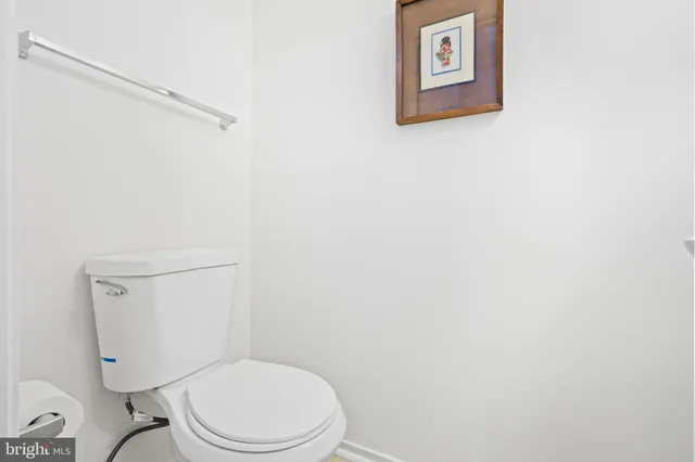 a white toilet sitting next to a shower