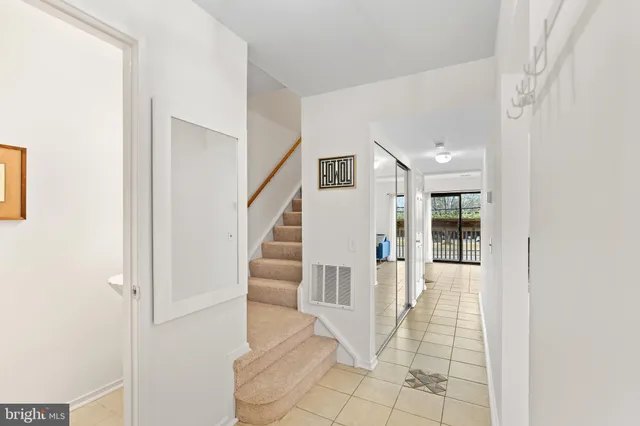 a view of staircase with white walls and windows