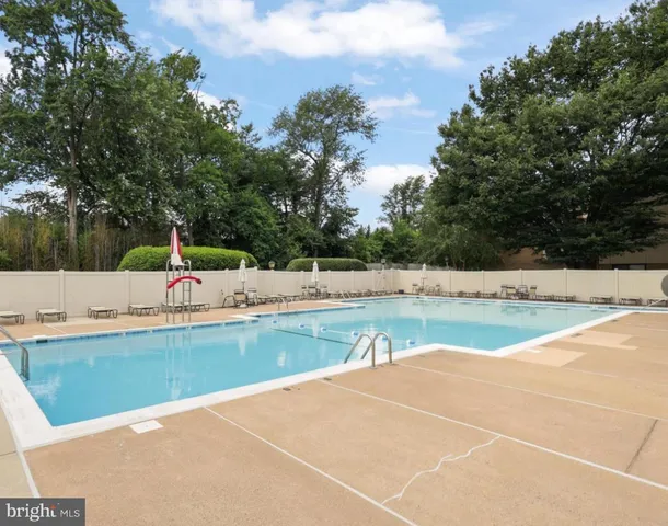 a view of a swimming pool with a yard