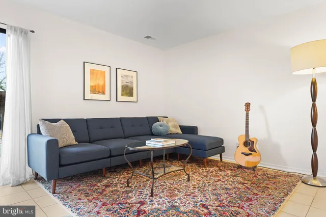 a living room with furniture and a lamp