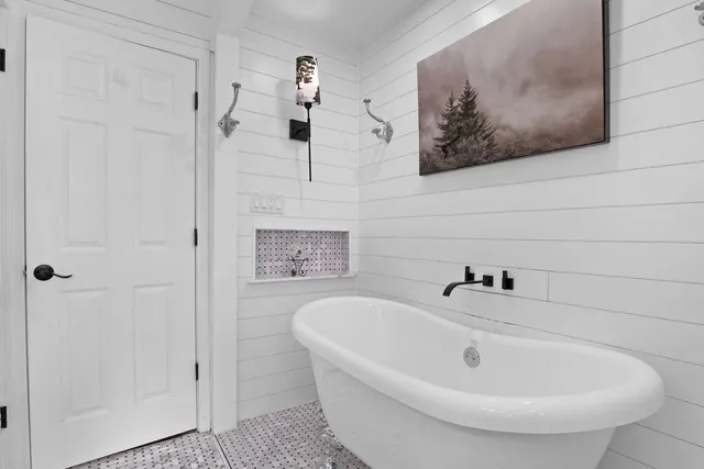 a bathroom with a tub and shower