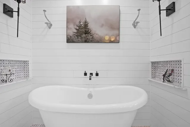 a white bath tub sitting in a bathroom