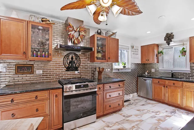 a kitchen with stainless steel appliances granite countertop a stove and cabinets
