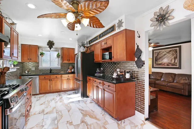 a kitchen with stainless steel appliances granite countertop a stove and a wooden cabinets