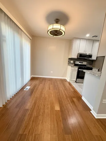 a view of a room with wooden floor