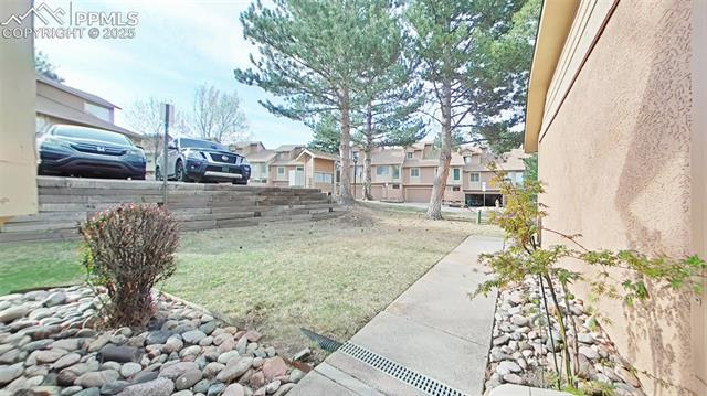 460 Autumn Ridge Circle, Unit D Colorado Springs, CO 80906 - Photo 17 of 38 View of yard with fence and a residential view