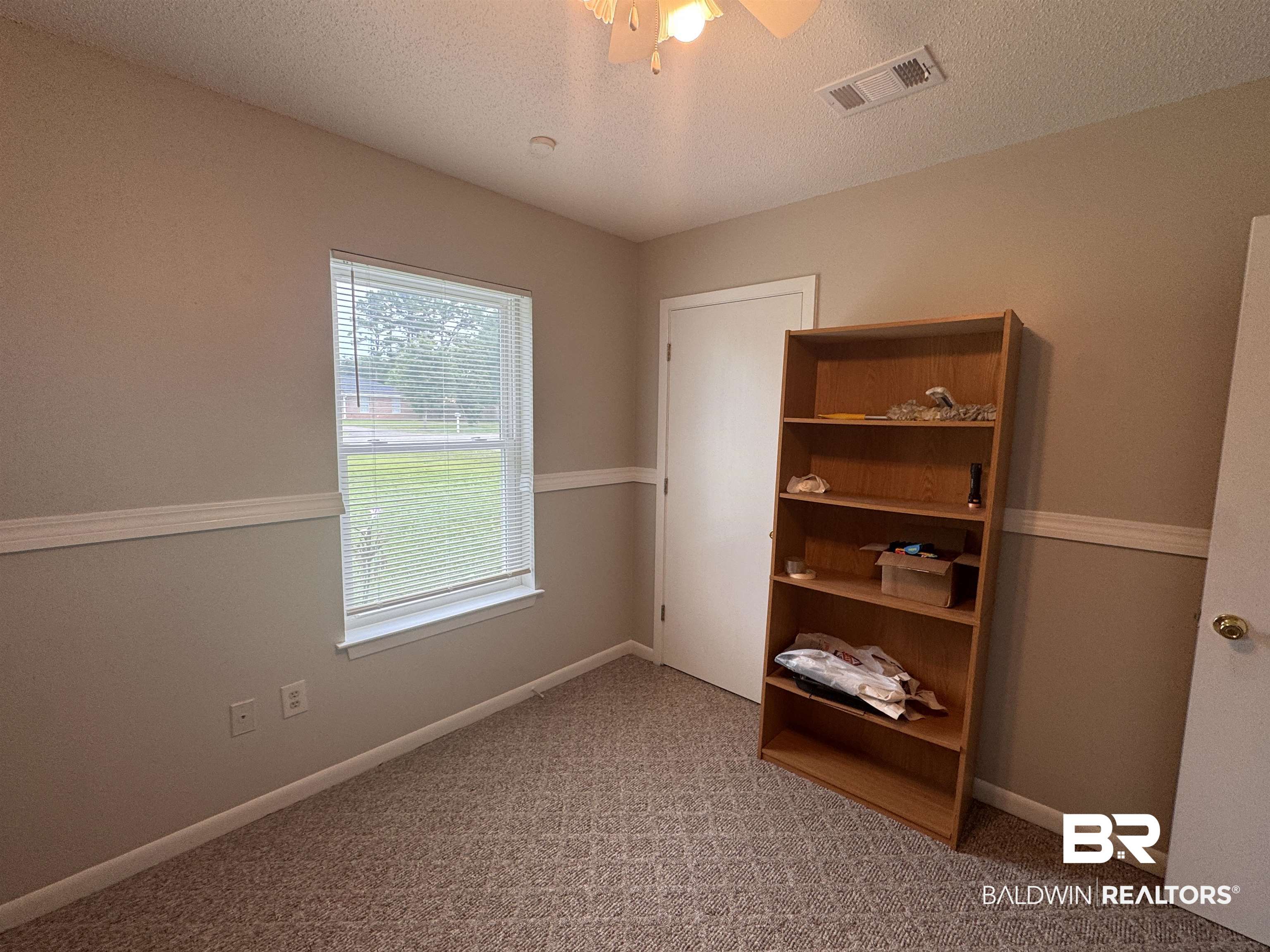 15148 Highland Circle Foley, AL 36535 - Photo 33 of 47 Carpeted empty room featuring a textured ceiling, a ceiling fan, and baseboards