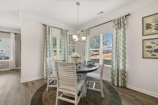 a dining room with furniture and window