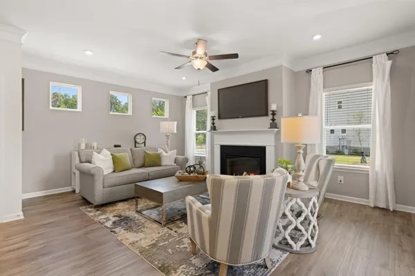 a living room with furniture a fireplace and a flat screen tv