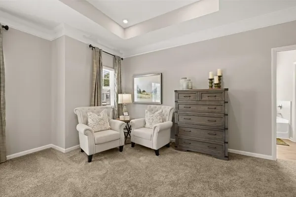 a living room with furniture and a dresser