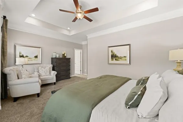 a spacious bedroom with a bed and a couch