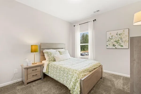 a bedroom with a bed and a dresser