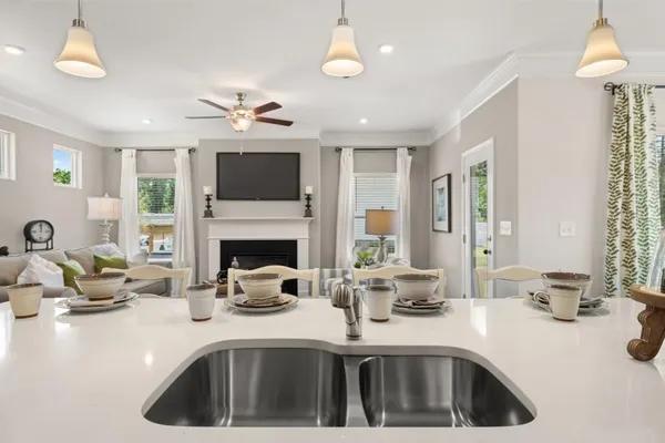 a kitchen with a sink cabinets and a fireplace