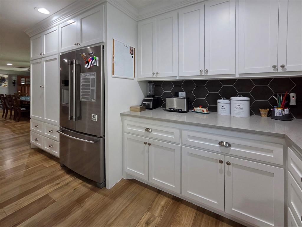 1023 Ridgefield Drive Plano, TX 75075 - Photo 12 of 39 a kitchen with stainless steel appliances granite countertop a refrigerator and white cabinets