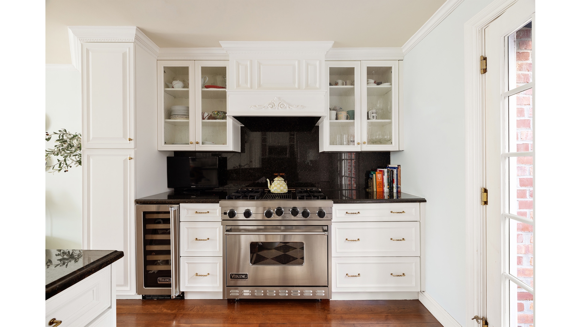 13 Commerce Street Manhattan, NY 10014 - Photo 4 of 13 a kitchen with white cabinets and appliances