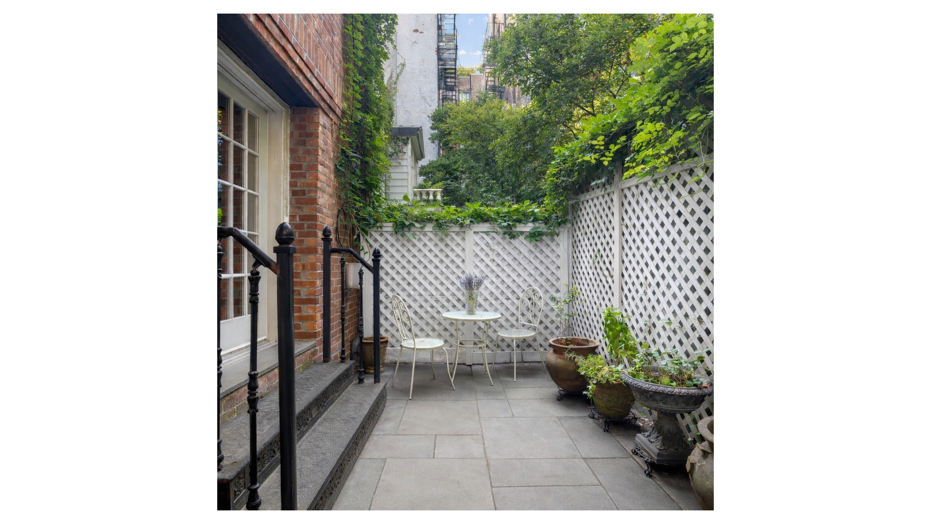 13 Commerce Street Manhattan, NY 10014 - Photo 5 of 13 a view of a balcony with chair and potted plants