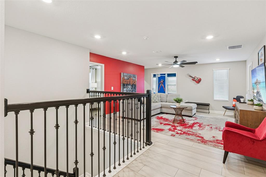 2949 Protagonist Street Kissimmee, FL 34746 - Photo 25 of 93 a view of a hallway with dining room and wooden floor