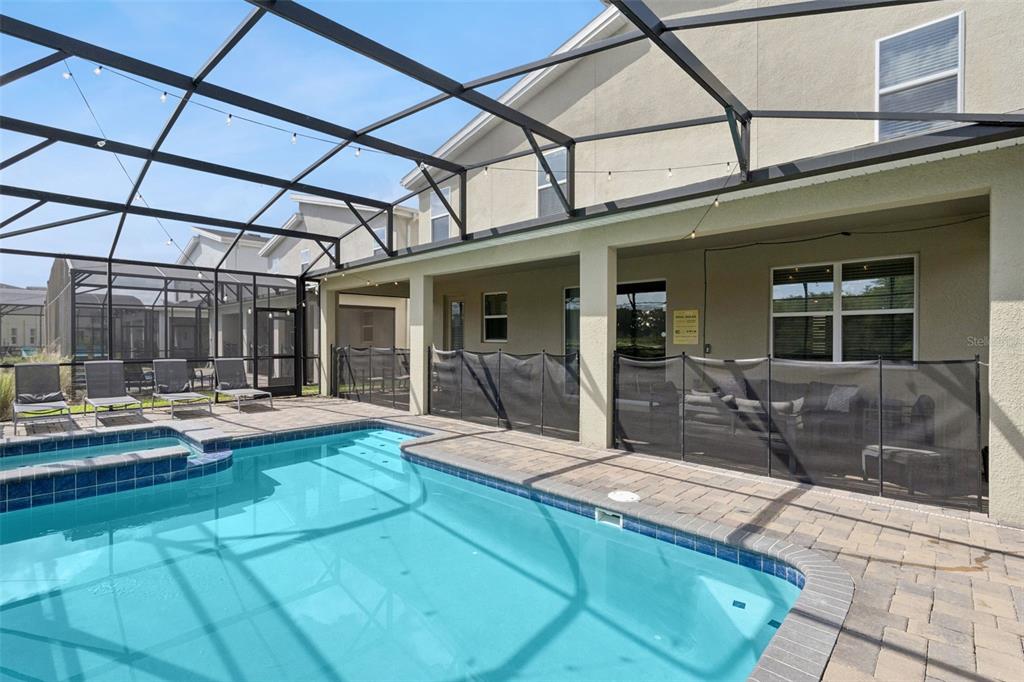 2949 Protagonist Street Kissimmee, FL 34746 - Photo 54 of 93 a view of a backyard with swimming pool table and chairs
