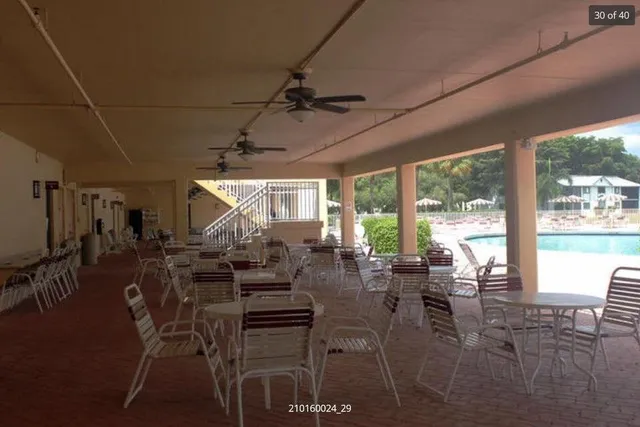 a view of a patio with table and chairs a barbeque with wooden floor