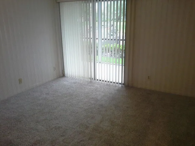 a view of empty room with floor to ceiling window
