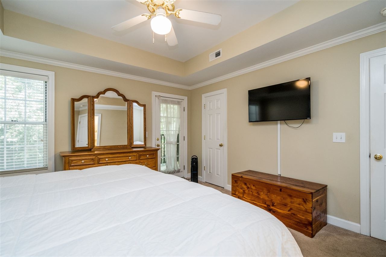 7016 Sandy Forks Road, Unit 201 Raleigh, NC 27609 - Photo 18 of 28 Enjoy this beautiful master suite with tray ceiling, plenty of natural light, ceiling fan and access to private balcony! Master Bedroom