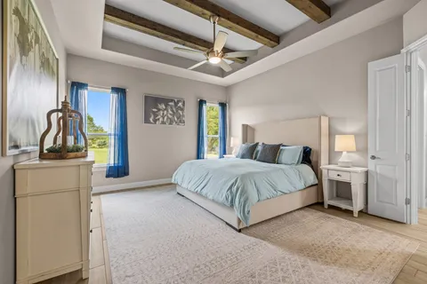 a spacious bedroom with a bed and a dresser