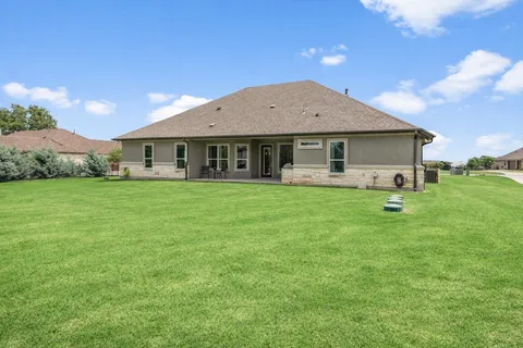 a front view of a house with a yard and porch