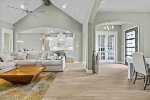 a living room with furniture and a chandelier