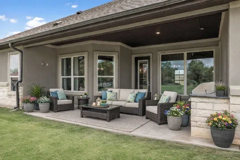 a living room with furniture potted plant and windows