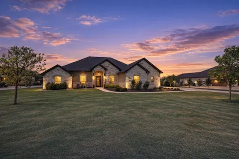 a front view of house with outdoor space and trees