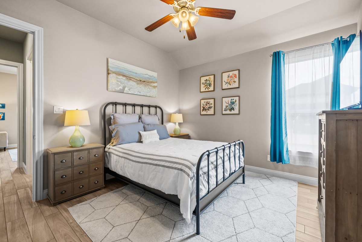329 Independence Drive Georgetown, TX 78633 - Photo 24 of 34 a bedroom with a bed and a chandelier