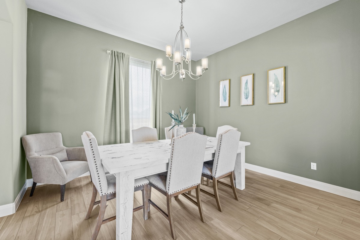 329 Independence Drive Georgetown, TX 78633 - Photo 9 of 34 a view of a dining room with furniture a chandelier and wooden floor