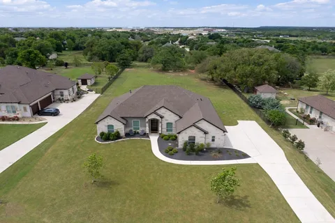 an aerial view of a house with garden space and street view