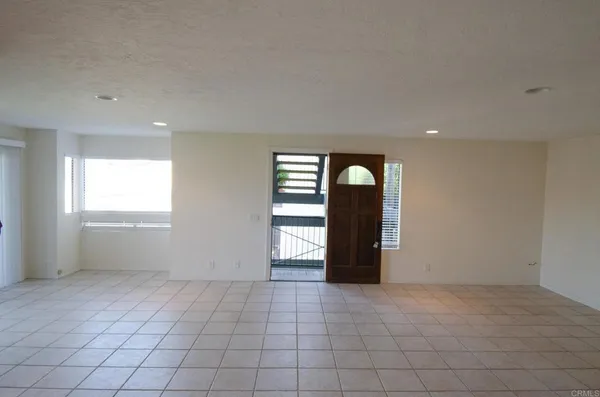 an empty room with windows and closet