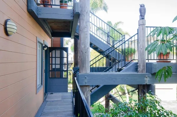 a view of balcony with two chairs and a potted plant