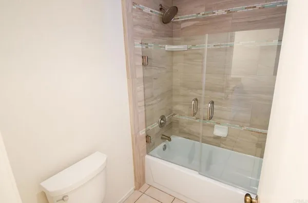 a bath room with a toilet and a bath tub