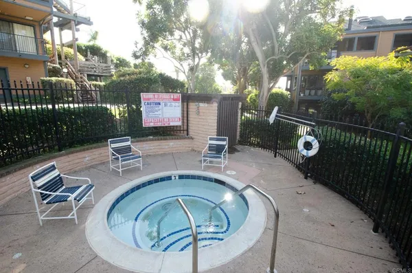 a view of a chairs and tables in backyard