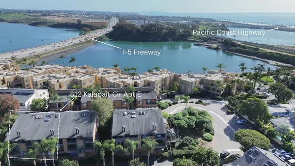 an aerial view of houses with a lake